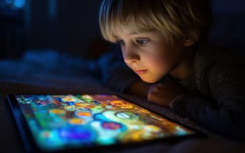 نگاه کودک به صفحه تبلت در تاریکی